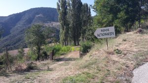 sign and road to the schoolhouse