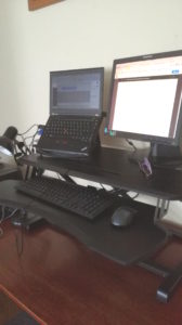 Desk riser with a laptop and monitor on top of a desk